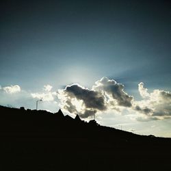 Low angle view of silhouette trees against sky