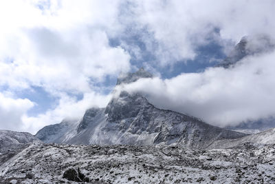 Scenic view of mountains against cloudy sky