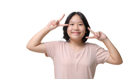 Portrait of young woman gesturing against white background