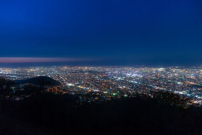 High angle view of illuminated buildings in city at night