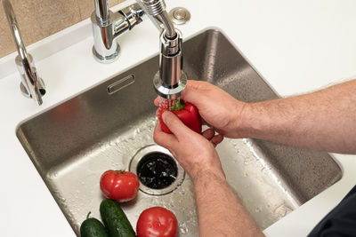 Cropped hand of person washing hands