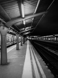 Illuminated railroad station platform at night