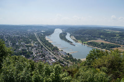 High angle view of city by river against sky