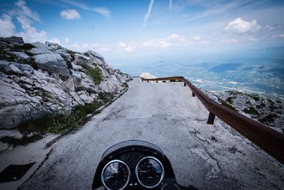 Bicycle on road by mountain against sky