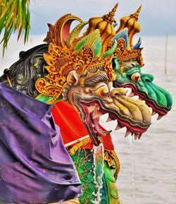 Low angle view of multi colored statue on water
