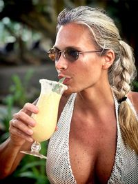 Portrait of young woman holding drink