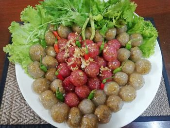 High angle view of chopped fruits in bowl on table