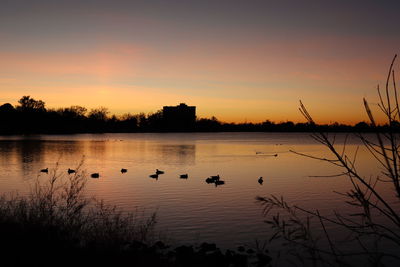 Scenic view of lake against sky during sunset