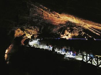 People in illuminated park at night