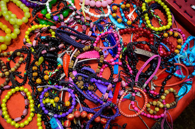 High angle view of multi colored jewelry for sale at market