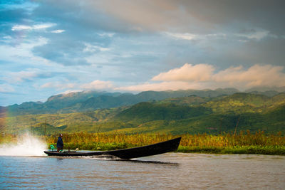 Scenic view of boat sailing on river against sky