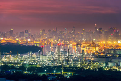 High angle view of illuminated buildings against sky at night