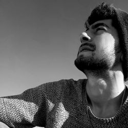 Portrait of young man looking away at home