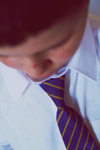 Close-up of boy wearing shirt and tie