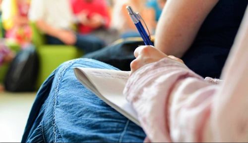 Low section of person reading book