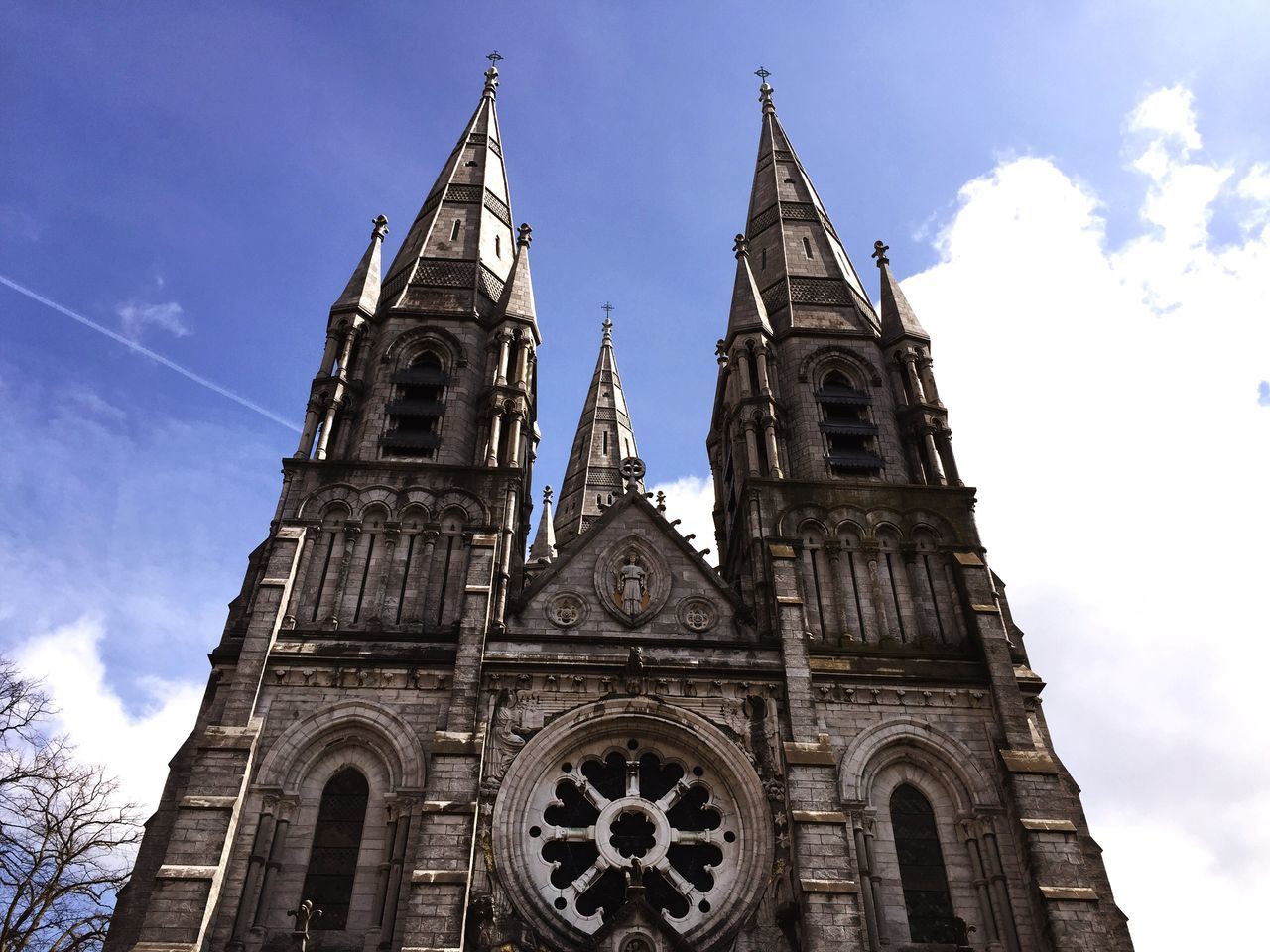 religion, low angle view, church, place of worship, architecture, spirituality, building exterior, built structure, cathedral, sky, cross, clock tower, tower, blue, clock, day, steeple, history