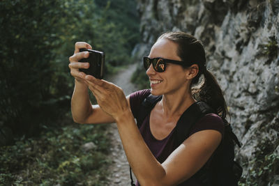 Young man photographing camera on mobile phone