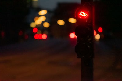 Close-up of road signal at night