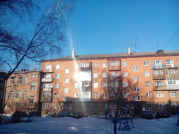 Buildings in city against cloudy sky