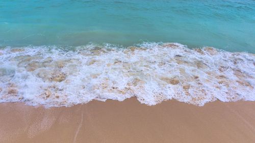 High angle view of waves rushing towards shore