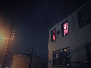 Low angle view of illuminated building against sky at night