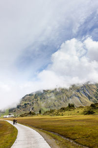 Road by mountain against sky