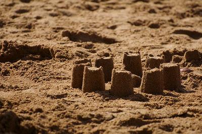 Close-up of mural on sand at beach