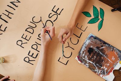 Cropped hand of person with text on paper