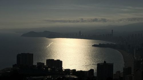 High angle view of silhouette buildings against sky during sunset