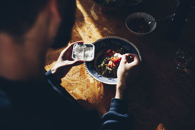 High angle view of man preparing food on table