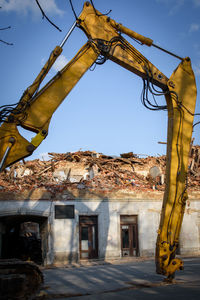 Low angle view of damaged building against sky