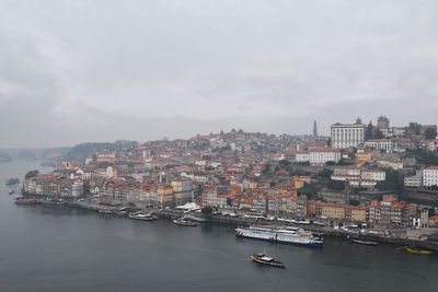 High angle view of buildings by sea against sky