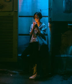 Low angle view of man standing against wall