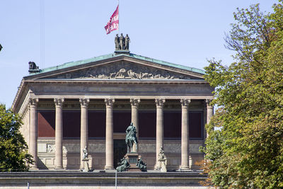 Low angle view of statues against sky