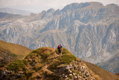 Rear view of man walking on mountains