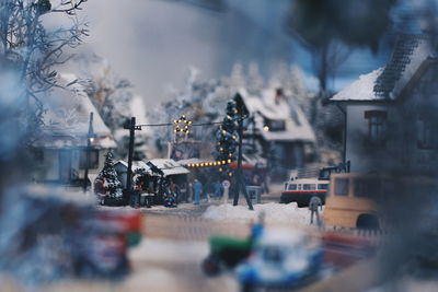 People on street amidst buildings in city