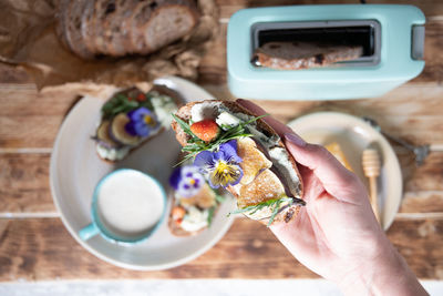 Delicious bruschetta with homemade bread, garnished with fig,soft cheese,pansies