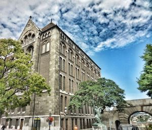 Low angle view of building against cloudy sky