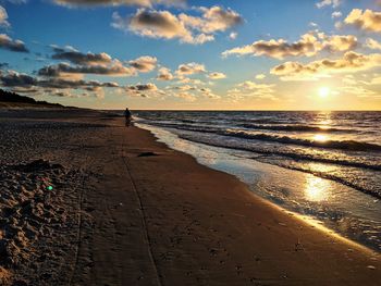 Scenic view of beach against sky during sunset