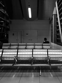 Rear view of people walking on escalator