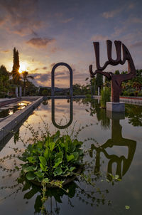 Scenic view of lake against sky at sunset