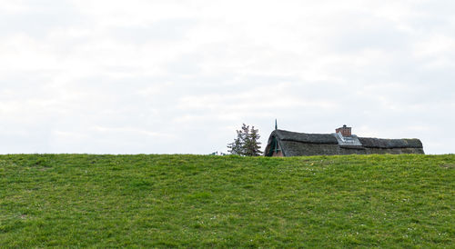 House on field against sky