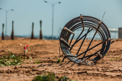 Close-up of bicycle on field against sky