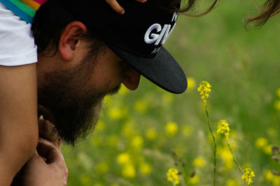 Close-up of man with flowers