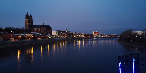 Illuminated buildings in city at waterfront