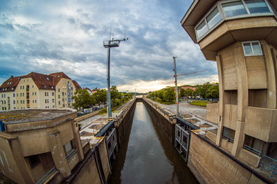 Bridge over canal amidst buildings in city