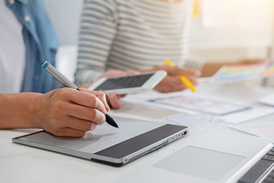 Cropped image of man using laptop on table
