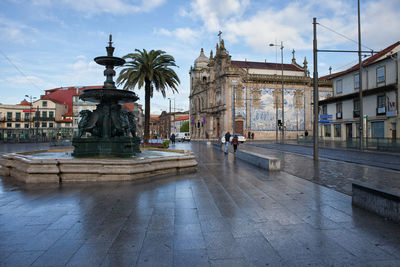 Statue in temple against buildings in city