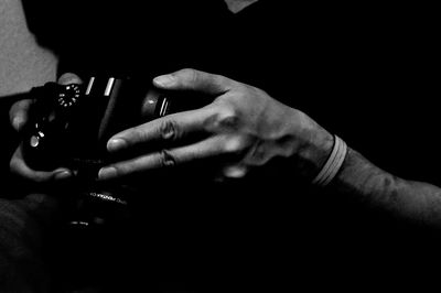 Cropped image of hand holding glass over white background