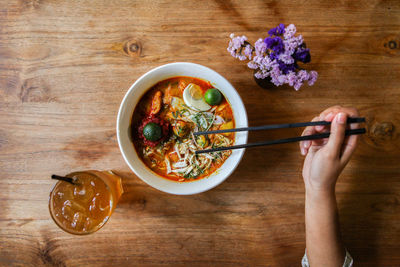 High angle view of hand having food on table